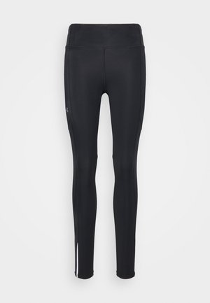 Leggings de sport noirs en matière extensible. Dotés d'une taille haute, de jambes fuselées et d'accents rayés blancs au niveau de l'ourlet.