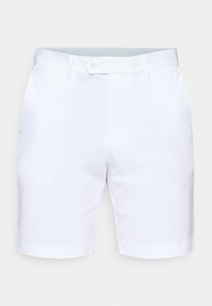 White shorts made of textured fabric, featuring a button closure, belt loops, and rolled-up hems. Clean, minimalist design with no patterns.