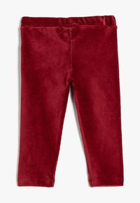 Czerwone legginsy z korduroy o miękkiej, teksturowanej powierzchni, z elastycznym pasem w talii i dopasowanym krojem, odpowiednie do codziennego noszenia.