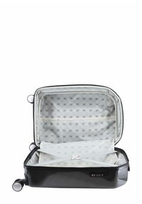 Black hard-shell suitcase with a zipper, interior lined in light patterned fabric, includes a cross strap and a combination lock on the side.