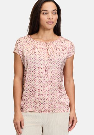 Blusa a maniche corte con un motivo geometrico rosa, tessuto leggero, scollatura arricciata e vestibilità comoda.