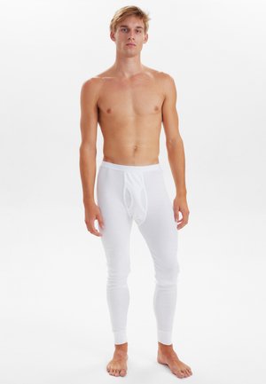 Hvide termoleggings med tætsiddende design og elastisk talje. Lavet af blødt, strækbart materiale, med en frontlomme og ribbede manchetter.