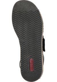 Svart gummiskosula med zigzag-mönster och en röd logotyp. Har en slät kant och sidöggla för enkel påtagning. Storlek angiven som 37.