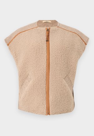 Beige fleece vest with a zip front, cap sleeves, and angled side pockets. Features contrasting tan accents along the edges and zipper.