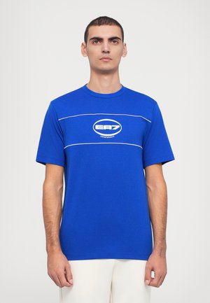 Blue short-sleeve T-shirt with a crew neck. Features white accent lines and a central EA7 logo. Made from a smooth, lightweight fabric.