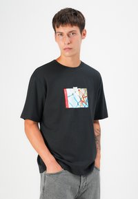 Black short-sleeve t-shirt featuring a colorful graphic print with a basketball hoop on the front. Made of soft fabric, relaxed fit.