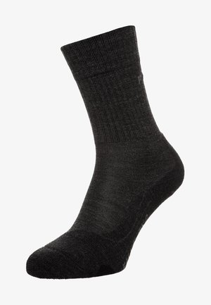 Calcetín de crew negro hecho de tela texturizada, con puño acanalado, refuerzo en el talón y en la punta, y cuerpo liso, apto para uso casual.