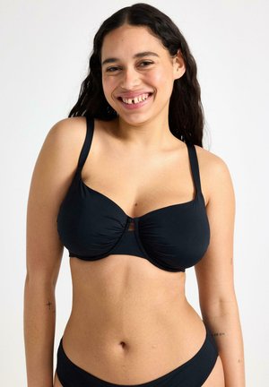 Černý bikinový top s tvarovanými košíčky, nastavitelnými ramínky a středovým detailem ve tvaru klíčové dírky. Hladká tkanina s mírným nařasením pro lepší přizpůsobení.