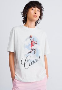 Light grey cotton t-shirt featuring a colorful graphic of a basketball player jumping. The text "Ciao!" is printed in a cursive font below.