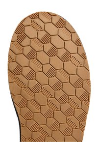 Gummisulor med ett bikupemönster som har växelvis släta och texturerade sektioner i tanfärg.
