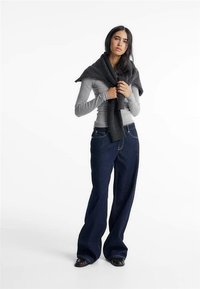 Long-sleeve gray top, dark wide-leg jeans, and a black scarf draped over shoulders, featuring soft fabric and casual fit.