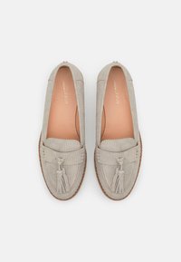 Light grey loafers with textured surface, rounded toe, and decorative tassels. Leather insole and stitched detailing around the edges.