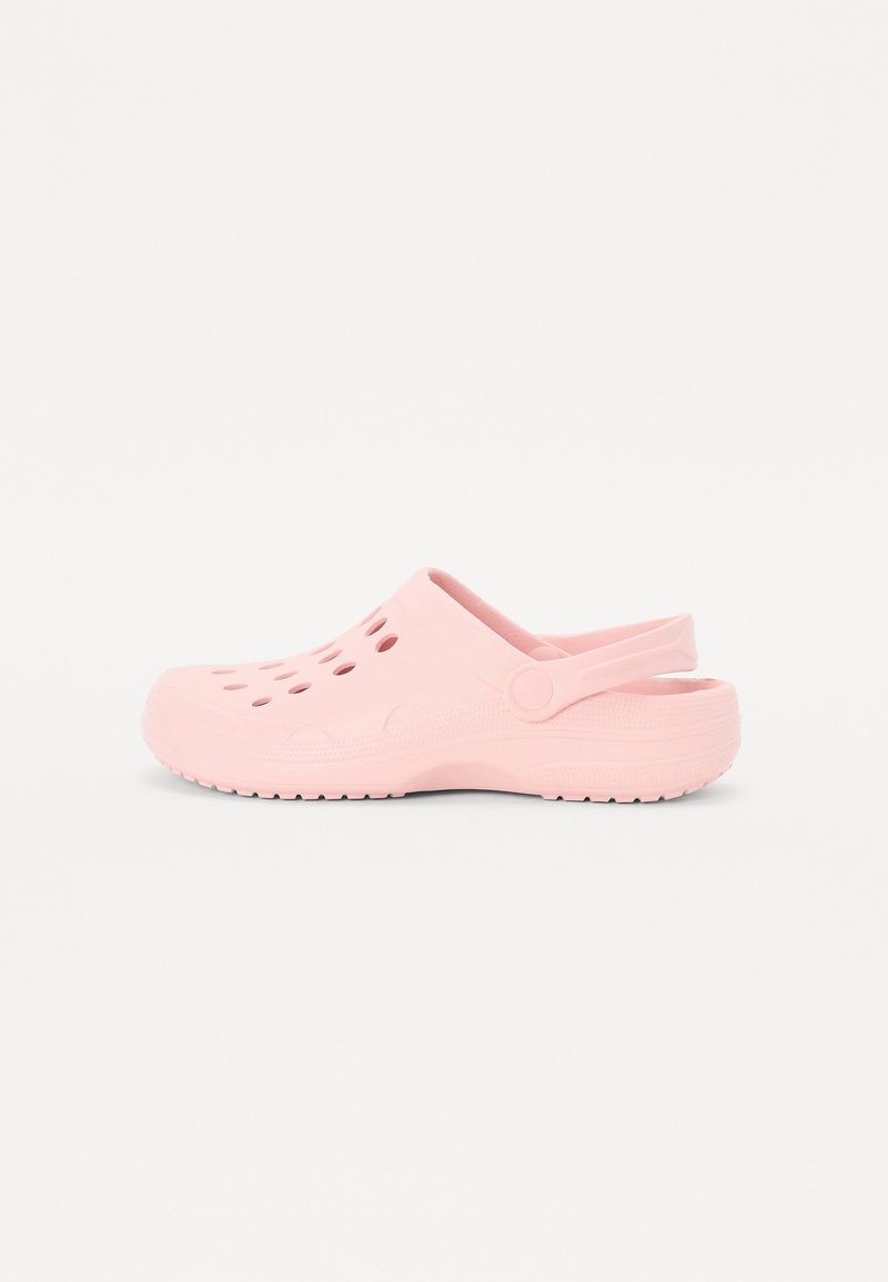 Pink clog, made of lightweight material, featuring ventilation holes, back strap, thick sole, and textured tread for grip.