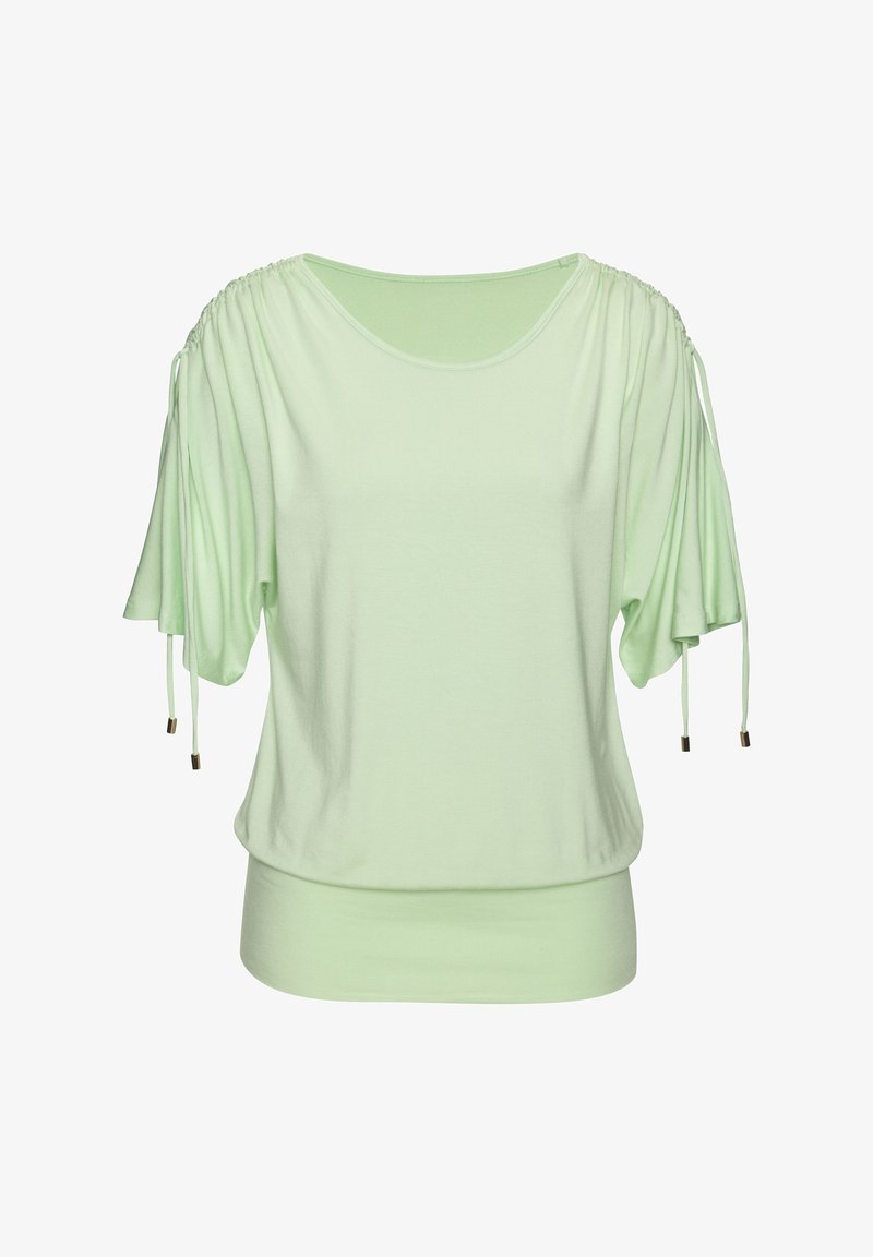 Blouse vert clair avec manches courtes froncées et cordons réglables, ourlet large ajusté à la taille.