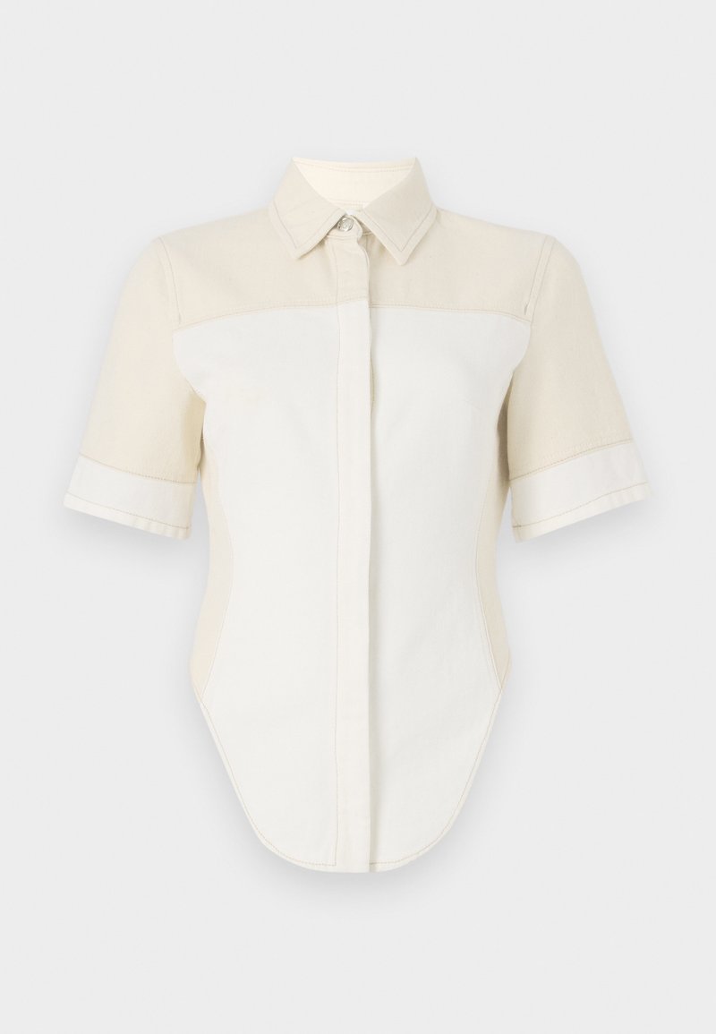 Short-sleeve shirt with a light beige and white color block design, featuring a pointed collar and button closure. Made from a smooth fabric.