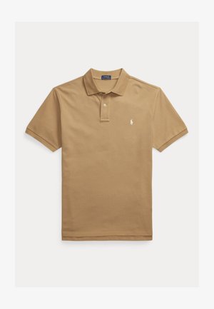 Tan polo shirt made of cotton with a classic collar, short sleeves, and a small embroidered logo on the left chest. Plain texture.