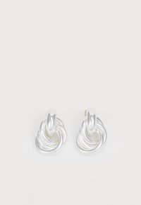 Boucles d'oreilles en argent présentant un design tordu et tourbillonnant avec une finition lisse. Des accents arrondis et polis rehaussent la forme sculpturale.