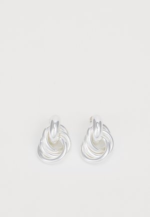 Silver earrings featuring a twisted, swirling design with a smooth finish. Rounded, polished accents enhance the sculptural shape.