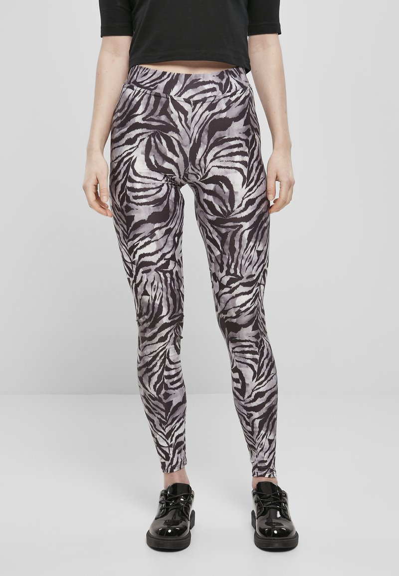 Fekete és szürke monokrom zebra mintás leggings; rugalmas anyagból készült, sima textúrával és rugalmas derékpánttal.