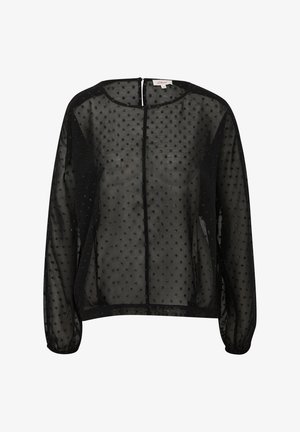 Blouse noire en voile avec un col rond, des manches longues et une fermeture à bouton dans le dos. Décorée de motifs en points texturés.