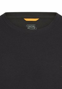 Sort bomuld T-shirt med rund halsudskæring og orange labeldetaljer på bagsiden. Har enkelt design og blød tekstur.