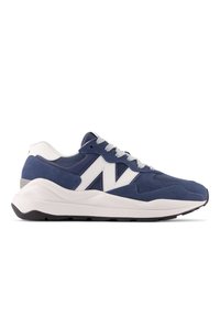 Dark blue suede athletic shoe with white accents, mesh detailing, and gray laces; features a thick, white cushioned sole and rubber outsole.