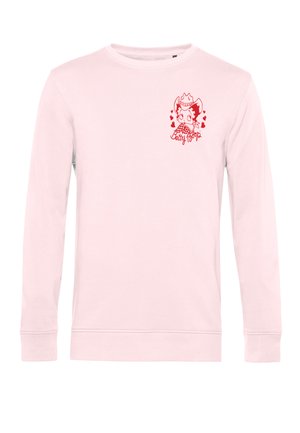 Jasnoróżowa koszula z długim rękawem z małą czerwoną grafiką Betty Boop w kapeluszu kowbojskim i serduszkami na lewej górnej części piersi.