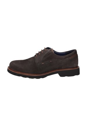Dark brown suede men's lace-up shoe with black sole and contrast brown stitching, side view, isolated on white background.