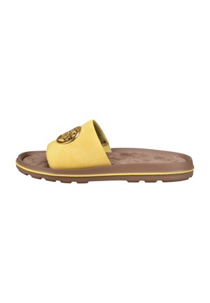 Yellow slide sandal with a brown cushioned sole and a gold circular logo on the wide upper strap.