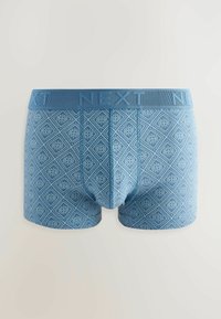 Blue boxer briefs with a diamond pattern and small circular accents. Elastic waistband features the text "NEXT" in a matching shade of blue.