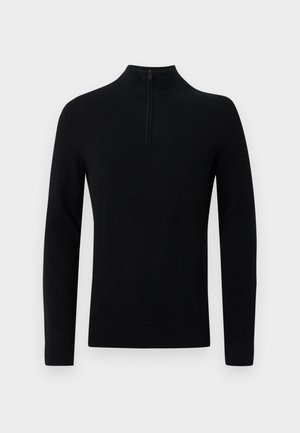 Svart tröja med hög krage, prydd med en kort dragkedja vid nacken. Tillverkad av mjukt stickat material, utan dekorationer och utan synliga mönster.