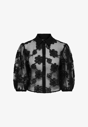 Melnā caurspīdīgā blūze ar ziedu izšuvumu, pogu aizdare priekšpusē un apkakle. Piedāvā puffētas piedurknes un teksturētu izskatu.