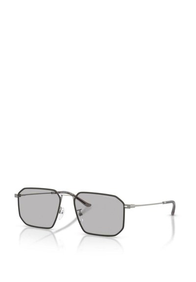Lunettes de soleil avec des verres gris octogonaux, monture en métal fin de couleur gris foncé et coussinets de nez transparents. Design minimaliste avec des branches élégantes.