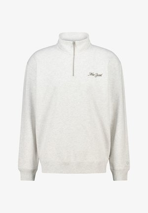 Light gray sweatshirt with a half-zip collar, featuring ribbed cuffs and hem. "New York" embroidered in cursive on the left chest.
