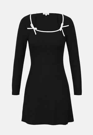 Black long-sleeve dress with a fitted bodice, square neckline, and white ties at the shoulders. Smooth texture with a flared hemline.