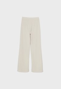 Light beige, wide-leg trousers made of soft fabric with an elastic waistband and no visible fastenings or patterns.