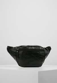Borsa nera in ecopelle con un motivo texturizzato a coccodrillo, dotata di chiusura superiore con zip e due cinturini laterali in tessuto per il trasporto.