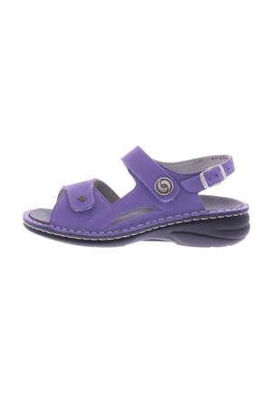 Purple synthetic sandal with an open toe, adjustable strap, and circular metal accent. Features a cushioned footbed and black outsole.