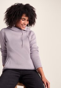 Lavender knit hoodie with a drawstring, two side pockets, and three-quarter sleeves. Textured fabric, relaxed fit, and subtle sheen.