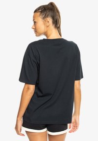 Black short-sleeve t-shirt made from cotton, featuring a classic cut and a smooth texture, with a simple, unembellished design.