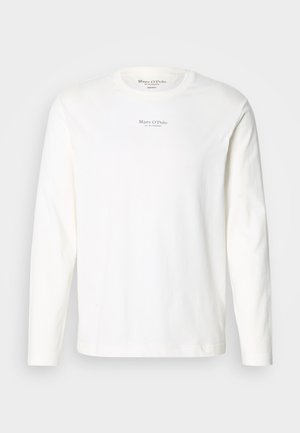 Long-sleeve white cotton t-shirt. Features a crew neck and small black logo text centered on the chest. Soft texture, casual design.
