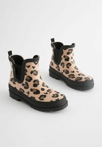 Bottes de pluie au motif léopard en beige et noir, avec une texture en caoutchouc lisse, hauteur à la cheville et semelle antidérapante, dotées de languettes pour un enfilage facile.