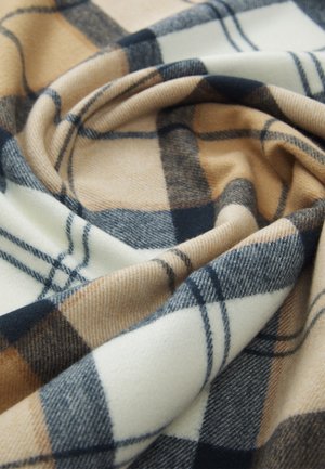 Plaid fabric featuring tan, cream, and navy blue colors; soft texture with a wavy appearance; prominent check pattern with varying sizes.