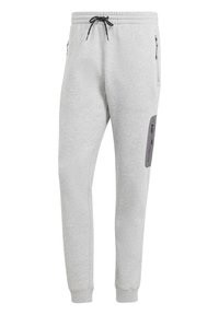 Grå sweatpants gjorda av mjukt tyg med resårmidja, sidofickor med dragkedja och en lappficka på låret med dragkedja.