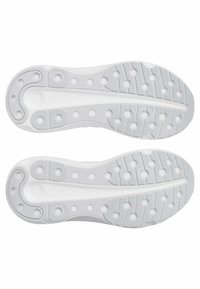 White athletic shoe soles with textured grip patterns, featuring circular indentations and a smooth central section with branding.