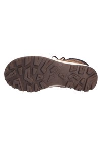 Semelle en caoutchouc marron avec un motif texturé, comportant des rainures profondes et des formes angulaires pour une meilleure adhérence. Construction robuste avec une touche beige.