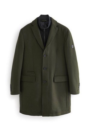 Manteau pour homme en mélange de laine vert foncé avec trois boutons sur le devant, col à revers, poches à rabat, et une couche intérieure noire zippée visible au niveau du col.