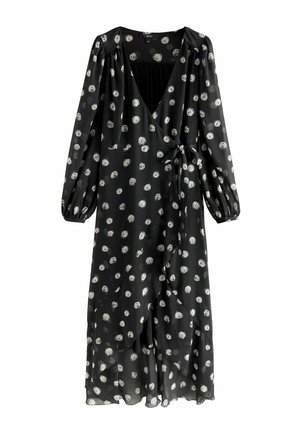 Schwarzes Wickelkleid mit langen Puffärmeln, das einen tiefen V-Ausschnitt und weiße, kreisförmige Muster aufweist. Hergestellt aus leichtem, durchscheinendem Stoff mit einem gebundenen Taillengürtel.