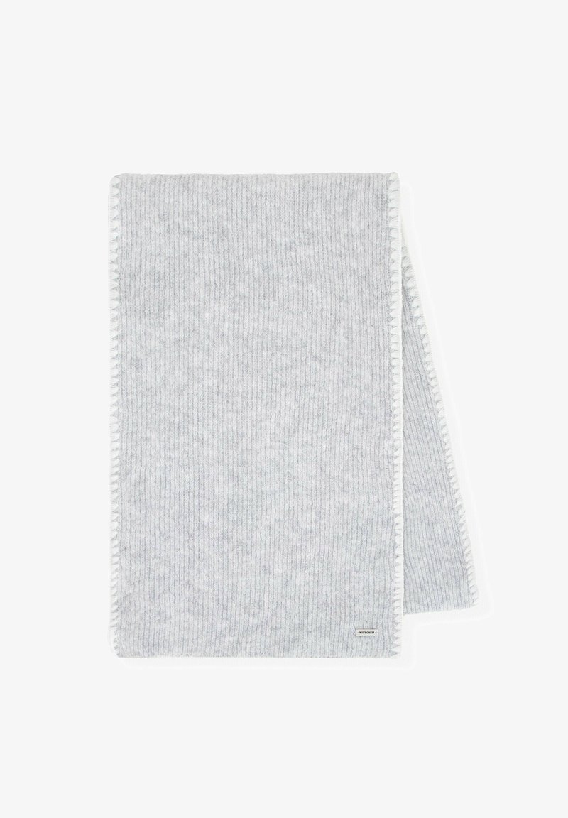 Coperta grigia a coste con una texture morbida, caratterizzata da un bordo bianco cucito a contrasto e una piccola etichetta con logo nell'angolo.