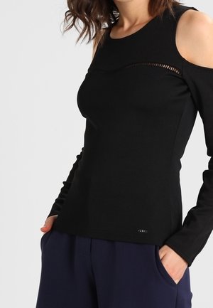 Zwarte longsleeve top met schouderuitsparingen, met een textuur strook over de borst en een aansluitend ontwerp. Gemaakt van gladde stof.